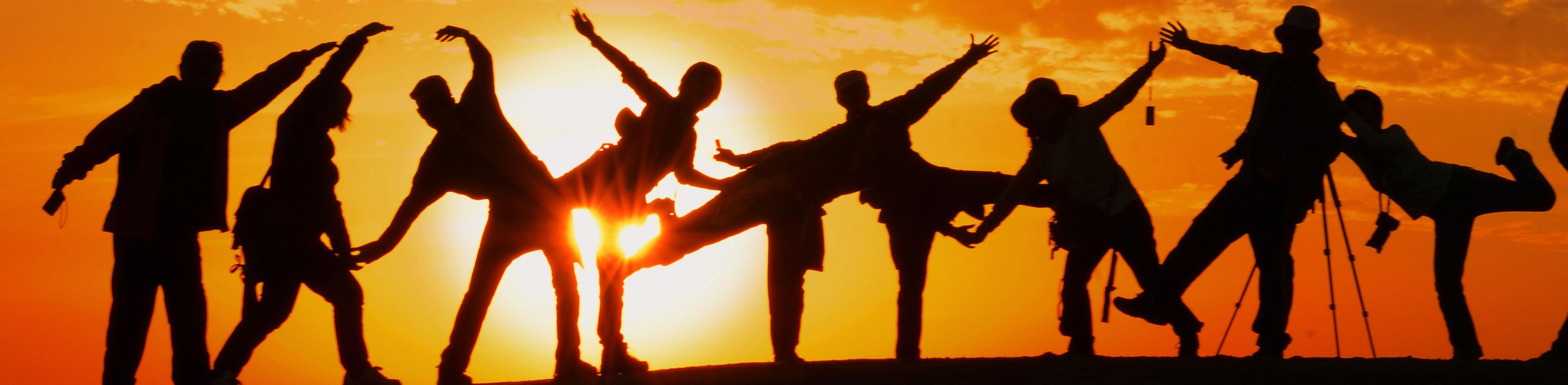 A photo of a group of children playing at sunset